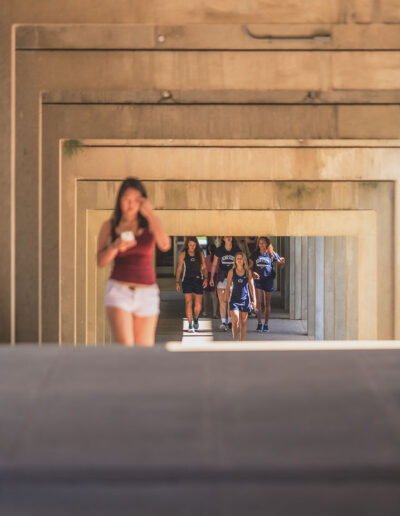 Students walking in a cooridor in the summer.
