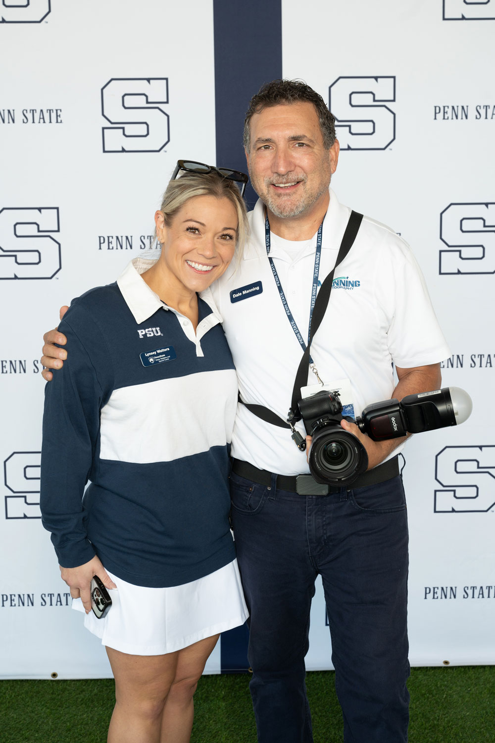 tailgate-backdrop-2 Two people standing in front of photo backdrop